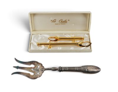 pair of silver and gold - plated spoons and fork in a box