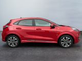 the red honda hrx is parked in a parking lot