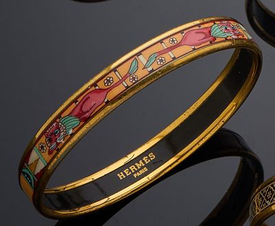 several different colored bang bracelets on a black surface with a black background