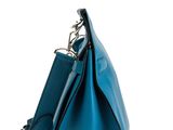 a blue leather handbag on a white background