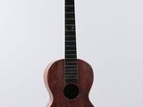 a close up of a small wooden guitar on a white background