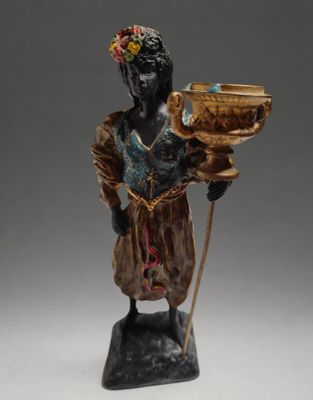 figurine of a woman holding a bowl and a stick
