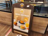 a menu board with a picture of a sandwich on it