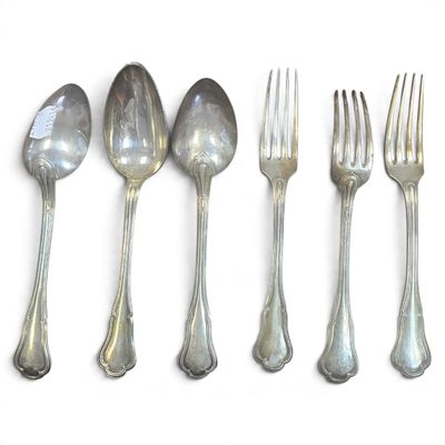five spoons and a fork on a white surface