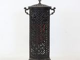 a small black candle holder on a white background