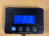 a digital clock on a table with a charger