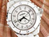 a white watch sitting on top of a seashell