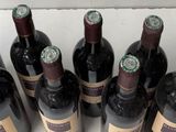 bottles of wine are lined up in a row on a table