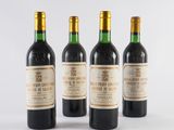 three bottles of wine sit next to each other on a white surface