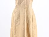 a woman ' s tan dress with fringes on a mannequin mannequin
