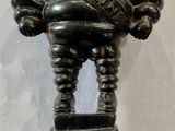 a bronze statue of a man holding a ball