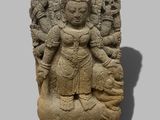 a stone statue of a woman holding a child