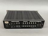a close up of a black radio receiver sitting on top of a table