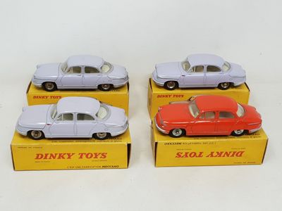 three toy cars are sitting in a box on a white surface