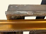 a wooden bench that is sitting in front of a wall