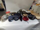 a table with many hats and hats on it