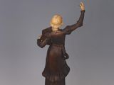 statue of a woman holding a bird on a marble base