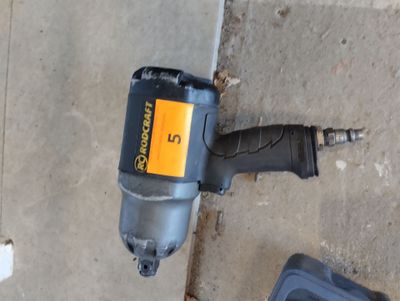 an image of a cordless drill on the ground