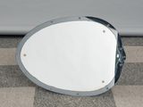 a mirror sitting on the ground next to a car