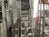 many ladders that are in a room with a window