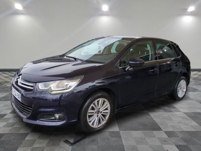 a blue car is parked in a room with a checkered floor
