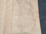 an open book with a drawing of a triangle and a triangle on it