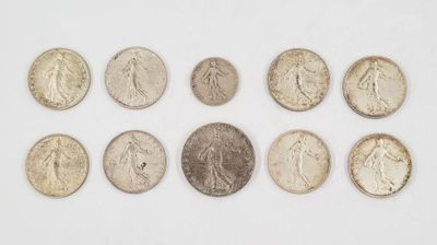 a group of coins sitting on top of a white surface