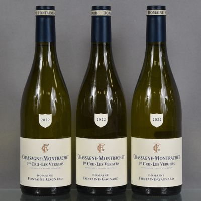 three bottles of white wine are lined up on a table