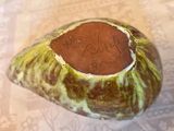 a small piece of fruit that has a brown substance on it