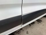 the side of a white car with a black stripe on it