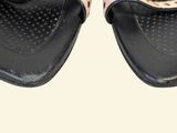 pair of women ' s black and pink sandals with polka dots on them
