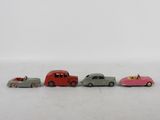 several toy cars are lined up in a row on a white surface