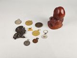 a close up of a small statue of a person surrounded by other items