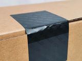 a close up of a cardboard box with a black tape on it