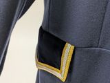 a close up of a person ' s jacket with a gold buckle