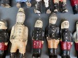many wooden figurines of different sizes and colors