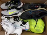 several pairs of shoes are in a box on the floor