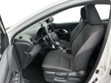 the interior of a car with the door open and the driver ' s seat down