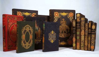 many books that are lined up together on a table