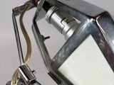 a silver lamp that is on a metal stand