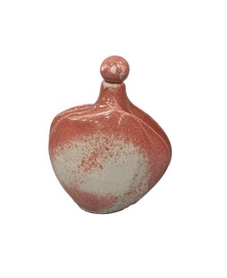 a red and white vase on a white background