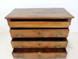 an image of a wooden chest of drawers with brass handles