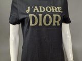 a mannequin wearing a black t - shirt with the word ' adore dior ' on it