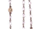 beaded rosary with a cross on a chain on a white background