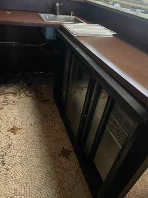 a kitchen with a sink and a counter in it