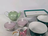 a lot of tea cups and saucers sitting on a table