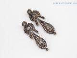 pair of antique silver and diamond earrings on a white background
