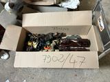 a cardboard box full of assorted items sitting on the floor