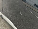 a close up of a car ' s door handle on the side of the road