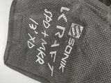 a pair of gloves with writing on them sitting on a table